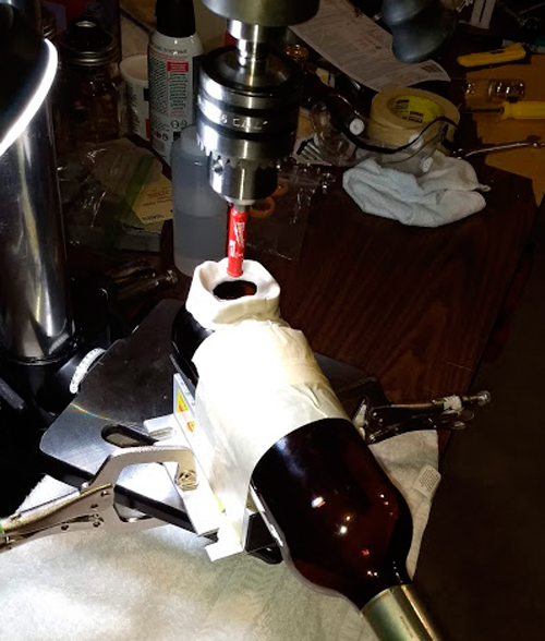Drilling a glass bottle with a bench  mounted press drill 